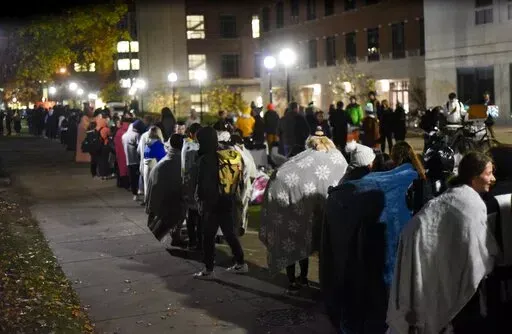 Hundreds of University of Michigan students waited in line for hours to register to vote at the Ann Arbor city clerk's satellite office at the university's Museum of Art on Tuesday, Nov. 8, 2022. (Ryan Stanton/Ann Arbor News via AP)