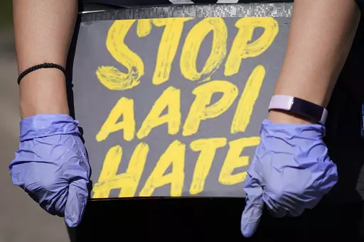 A person holds a sign and attends a rally to support stop AAPI (Asian Americans and Pacific Islanders) hate at the Logan Square Monument in Chicago, on March 20, 2021. Despite ongoing efforts to combat anti-Asian racism that arose after the pandemic, a third of Asian Americans and Pacific Islanders say they have experienced an act of abuse based on their race or ethnicity in the last year. (AP Photo/Nam Y. Huh, File)