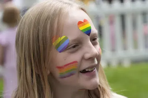 Bonneville Elementary School 5th grader Graham Beeton, is interviewed during a block party supporting trans and non binary students and staff Monday, April 29, 2024, in Salt Lake City. Utah will become the latest state to implement restrictions for transgender people using school bathrooms and locker rooms in public schools and government-owned buildings when key components of a law passed by the Republican controlled Legislature take effect May 1. (AP Photo/Rick Bowmer)