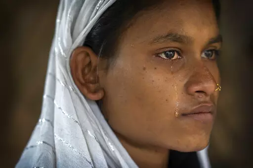 Nureja Khatun, 19, cries as she waits in her shanty home for her husband Akbor Ali to return, in Morigaon district of Indian northeastern state of Assam, Saturday, Feb. 11, 2023. Khatun's husband is one among more than 3,000 men, including Hindu and Muslim priests, who were arrested nearly two weeks ago in the northeastern state of Assam under a wide crackdown on illegal child marriages involving girls under the age of 18. (AP Photo/Anupam Nath)