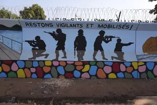 A mural is seen in Ouagadougou, Burkina Faso, Wednesday March 1, 2023. Three survivors of an attack in Zaongo, central Burkina Faso, told AP that dozens of people were killed in their village on Nov. 5 when security forces attacked. One of the survivors, a 32-year-old farmer, said he photographed the horrific scenes of bodies as proof of the carnage before fleeing. (AP Photo, File)