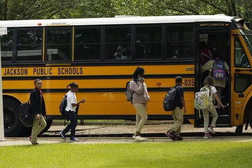 Spann Elementary School students board a school bus following a full day of in-school learning, Sept. 6, 2022, in Jackson, Miss. After the COVID-19 pandemic disrupted schools around the country and led to more children missing classes, the number of students who were chronically absent in Mississippi declined during the most recent school year, according to data released, Tuesday, Sept. 26, 2023, by the state's education department. (AP Photo/Rogelio V. Solis, File)