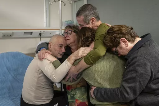 Hostage Luis Har, left, is hugged by relatives after being rescued from captivity in the Gaza Strip, at the Sheba Medical Center in Ramat Gan, Israel, Monday, Feb. 12, 2024. Israeli forces rescued two hostages early Monday, storming a heavily guarded apartment in the Gaza Strip and extracting the captives under fire in a dramatic raid that was a small but symbolically significant success for Israel. Marman was taken hostage by Hamas in cross-border attack in October last year. (Israeli Army via 