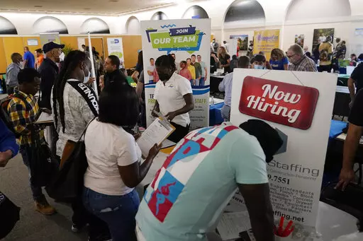Job applicants fill out forms with CSC Global, left, and Skilled Staffing, right, at the 305 Second Chance Job & Resource Expo, Friday, June 10, 2022, in Miami. America’s employers shrugged off high inflation and weakening growth to add 372,000 jobs in June, a surprisingly strong gain that will likely spur the Federal Reserve to keep sharply raising interest rates to try to cool the economy and slow price increases. The unemployment rate remained at 3.6% for a fourth straight month, the govern