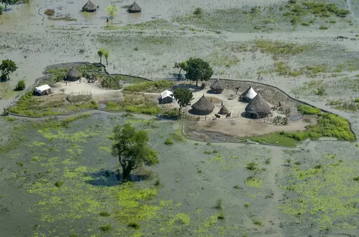 Thatched huts surrounded by floodwaters are seen from the air in Old Fangak county, Jonglei state, South Sudan, Nov. 27, 2020. South Sudan's President Salva Kiir Mayardit ordered the suspension Saturday, July 9, of all dredging-related activities in the country until evidence-based studies are carried out on their on surrounding communities and the ecosystems they rely on. (AP Photo/Maura Ajak, File)