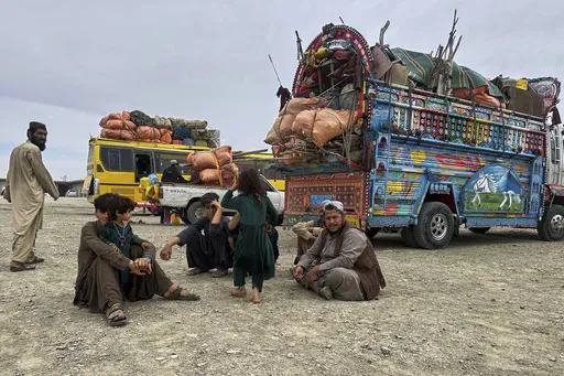 Afghan refugees take rest at a transit station setup to facilitate Afghan refugees' deportations, outskirt of Chaman, a town on the Pakistan and Afghanistan border, Tuesday, April 8, 2025. (AP Photo)
