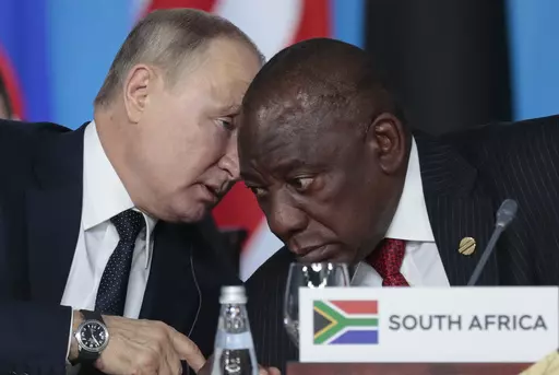 Russian President Vladimir Putin, left, speaks to South African President, Cyril Ramaphosa, right, during a plenary session at the Russia-Africa summit in the Black Sea resort of Sochi, Russia on Oct. 24, 2019. The U.S. ambassador to South Africa, Reuben Brigety, has accused South Africa of providing weapons to Russia saying the U.S. government was certain that weapons were loaded onto a cargo ship that docked secretly at a naval base near the city of Cape Town for three days in December. (Serge