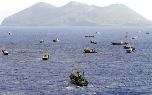 Foreign vessels, some of them have Chinese flags, fish near Torishima, Japan, on Oct. 31, 2014. A Chinese scientific ship bristling with surveillance equipment docked in a Sri Lankan port. Hundreds of fishing boats anchored for months at a time among disputed islands in the South China Sea. And ocean-going ferries, built to be capable of carrying heavy vehicles and large loads of people. (Kyodo News via AP)