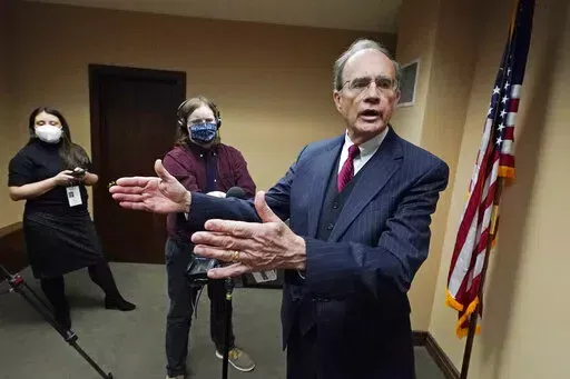 Mississippi Lt. Gov. Delbert Hosemann tells reporters Tuesday, Jan. 4, 2022, that the state should provide health insurance for working people, but sharply rebuffed a question about expanding Medicaid, at the Mississippi State Capitol in Jackson, Miss., following the start of the latest Legislative Session, Tuesday, Jan. 4, 2022. (AP Photo/Rogelio V. Solis)