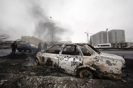 A car, which was burned after clashes, is seen on a street in Almaty, Kazakhstan, Friday, Jan. 7, 2022. Kazakhstan's president authorized security forces on Friday to shoot to kill those participating in unrest, opening the door for a dramatic escalation in a crackdown on anti-government protests that have turned violent. The Central Asian nation this week experienced its worst street protests since gaining independence from the Soviet Union three decades ago, and dozens have been killed in the 