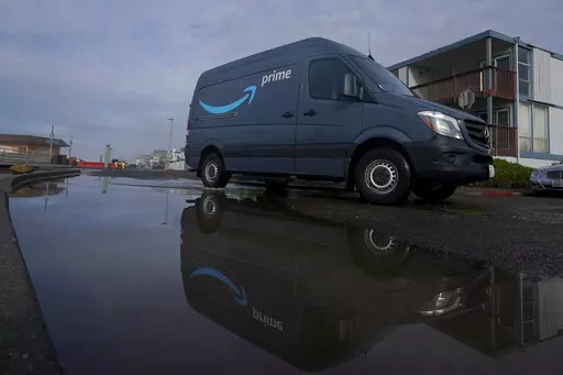 An Amazon Prime truck drives in Pacifica, Calif., on Dec. 15, 2020. Amazon has begun mass layoffs in its corporate ranks, becoming the latest tech company to trim its workforce amid rising fears about the wider economic environment. (AP Photo/Jeff Chiu, File)
