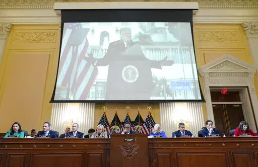 A video of former President Donald Trump speaking during a rally near the White House on Jan. 6, 2021, is shown as committee members from left to right, Rep. Stephanie Murphy, D-Fla., Rep. Pete Aguilar, D-Calif., Rep. Adam Schiff, D-Calif., Rep. Zoe Lofgren, D-Calif., Chairman Bennie Thompson, D-Miss., Vice Chair Liz Cheney, R-Wyo., Rep. Adam Kinzinger, R-Ill., Rep. Jamie Raskin, D-Md., and Rep. Elaine Luria, D-Va., look on, during a public hearing of the House select committee investigating the