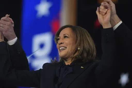 Democratic presidential nominee Vice President Kamala Harris celebrates with her families as the balloons fall during the final day of during the Democratic National Convention Thursday, Aug. 22, 2024, in Chicago. (AP Photo/Erin Hooley)
