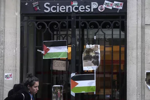 A student walks past th entrance of Sciences-Po university in Paris Friday, April 26, 2024. Students in Paris inspired by Gaza solidarity encampments at campuses in the United States blocked access to a campus building at a prestigious French university Friday, prompting administrators to move all classes online. The pro-Palestinian protest at the Paris Institute of Political Studies, known as Sciences Po, came two days after police broke up a separate demonstration at one of the university's am