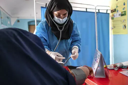 A Save the Children midwife provides Zarmina, 25, who is five months pregnant, with a pre-natal check-up in Jawzjan province in northern Afghanistan, Sunday, Oct. 2, 2022. (Save the Children via AP, File)