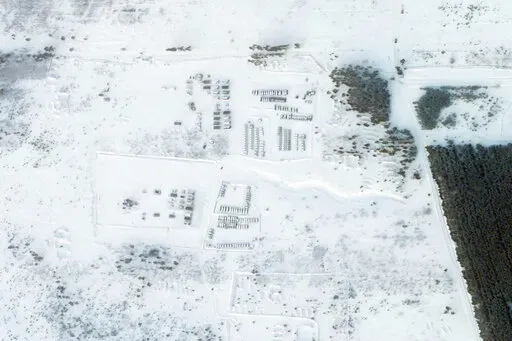 This satellite image provided by Planet Labs PBC shows vehicles and tanks stationed at the Pogonovo training area just south of the city of Voronezh, Russia, Wednesday, Jan. 26, 2022. Russia warned Wednesday it would quickly take "retaliatory measures" if the U.S. and its allies reject its security demands over NATO and Ukraine, raising pressure on the West amid concerns that Moscow is planning to invade its neighbor. (Planet Labs PBC via AP)