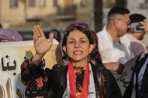 FILE- An Iraqi woman protests against a proposed law to permit underage female marriage in Tahrir Square in Baghdad, Iraq, July 28, 2024. Rights groups and many Iraqi women fear the country's parliament will open the door to child marriages as lawmakers consider legal changes that would give religious authorities more power over family law. (AP Photo/Hadi Mizban, File)