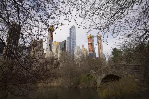 Skyscrapers overlook Central Park and Gapstow Bridge, April 17, 2018, in New York. According to officials, a man stabbed a pit bull to death following a quarrel with the dog's owner in New York City's Central Park. The seriously injured dog was transported to a local animal clinic, where he was euthanized after the stabbing Saturday evening, June 17, 2023, police said. (AP Photo/Mark Lennihan, File)
