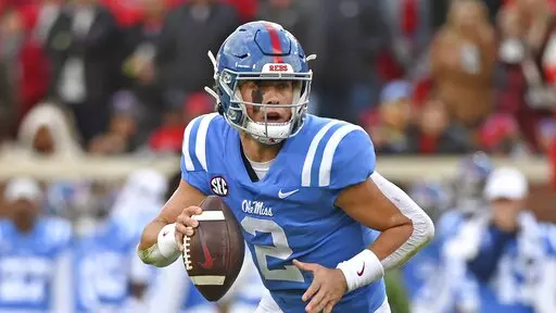 Mississippi quarterback Jaxson Dart (2) runs with the ball during the first half of an NCAA college football game against Alabama in Oxford, Miss., Saturday, Nov. 12, 2022. (AP Photo/Thomas Graning)