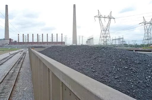 Coal is shown inside one of the train cars headed for the dumping area of the Shawnee Fossil Plant in western McCracken County, Ky. The nation's largest public utility has proposed building a $216 million solar farm project in Kentucky atop a capped coal ash storage pit at one of its coal-fired power plants. The federal Tennessee Valley Authority voted Thursday, Nov. 10, 2022 to advance the initiative at Shawnee Fossil Plant in Paducah. (John Wright/The Paducah Sun via AP)