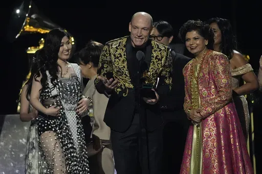 Eru Matsumoto, from left, Wouter Kellerman, and Chandrika Tandon accept the award for best new age, ambient, or chant album for "Triveni" during the 67th annual Grammy Awards on Sunday, Feb. 2, 2025, in Los Angeles. (AP Photo/Chris Pizzello)