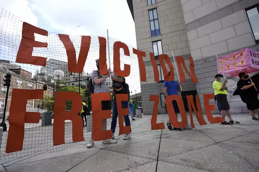 In this June 9, 2021, photo, people hold a sign during a rally in Boston protesting housing eviction. Housing advocates are raising the alarm about House Republicans' plan to dramatically cut the federal deficit to raise the debt ceiling, warning that struggling families could lose access to rental aid. (AP Photo/Elise Amendola, File)