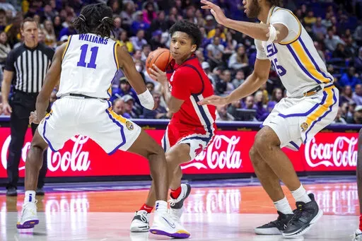 Mississippi guard Daeshun Ruffin (2) drives the ball as LSU's Justice Williams (11) and Efton Reid III defend during an NCAA college basketball game Tuesday, Feb 1, 2022, in Baton Rouge, La. (Scott Clause/The Daily Advertiser via AP)