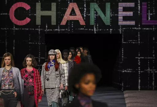 Models wear creations as part of the Chanel Ready To Wear Fall/Winter 2022-2023 fashion collection, unveiled during the Fashion Week in Paris, Tuesday, March 8, 2022. (Photo by Vianney Le Caer/Invision/AP)