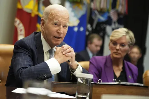 President Joe Biden speaks about the federal government's response to Hurricanes Milton and Helene as as Energy Secretary Jennifer Granholm listens, in the Roosevelt Room of the White House, Friday, Oct. 11, 2024, in Washington. (AP Photo/Manuel Balce Ceneta)