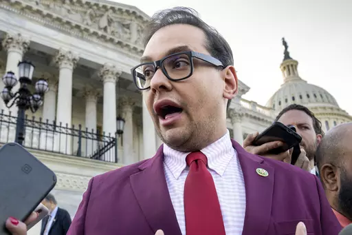Rep. George Santos, R-N.Y., speaks to reporters outside the Capitol, in Washington, May 17, 2023. Santos, 34, has spent weeks fighting efforts by news outlets to unseal the names of the two people who co-signed the $500,000 bond, which enabled his pretrial release as he awaits federal charges of fraud, money laundering and theft of public funds. (AP Photo/J. Scott Applewhite, File)