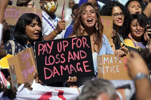 Mitzi Jonelle Tan, of the Philippines, center, participates in a Fridays for Future protest calling for money for climate action at the COP27 U.N. Climate Summit, Nov. 11, 2022, in Sharm el-Sheikh, Egypt. (AP Photo/Peter Dejong, File)
