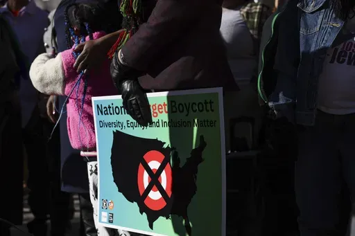 A community member holds a sign calling for a national boycott of Target stores during a news conference outside Target Corporation's headquarters Thursday, Jan. 30, 2025, in Minneapolis, Minn. (AP Photo/Ellen Schmidt, File)