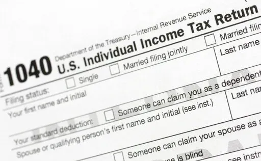 A portion of the 1040 U.S. Individual Income Tax Return form is shown July 24, 2018, in New York. The IRS said Tuesday, June 21, 2022, that it will have erased its backlog of last season's tax returns by the end of this week. (AP Photo/Mark Lennihan, File)