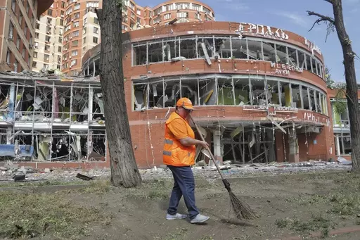 Municipal workers clean at the scene of a nightly Russian rocket attack in Odesa, Ukraine, Wednesday, June 14, 2023. Officials say Russian forces have fired cruise missiles at the southern Ukrainian city of Odesa overnight and shelling has destroyed homes in the eastern Donetsk region, killing at least six people and injuring more than a dozen others.(AP Photo/Nina Lyashonok)