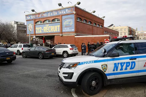 FILE -New York City police officers work the scene of a police involved shooting outside the 41st precinct Sunday, Feb. 9, 2020, in New York. A gunman who ambushed police in New York City twice in 12 hours, wounding two officers, has been sentenced to 23 years to life in prison, Friday, Oct. 20, 2023. (AP Photo/John Minchillo, File)
