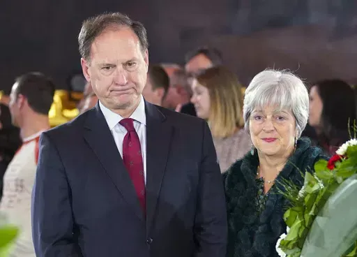 Supreme Court Justice Samuel Alito Jr., left, and his wife Martha-Ann Alito, pay their respects at the casket of Reverend Billy Graham at the Rotunda of the U.S. Capitol Building in Washington, Feb. 28, 2018. Alito rejects calls to step aside from Supreme Court cases on Trump and Jan. 6. (AP Photo/Pablo Martinez Monsivais, File)