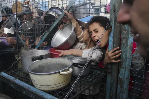 Palestinians line up to receive free meals at Jabaliya refugee camp in the Gaza Strip on March 18, 2024. (AP Photo/Mahmoud Essa, File)