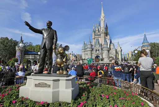 A statue of Walt Disney and Micky Mouse stands in front of the Cinderella Castle at the Magic Kingdom at Walt Disney World in Lake Buena Vista, Fla., Jan. 9, 2019. It’s going on six months since Bob Iger returned to The Walt Disney Co., and while there’s been plenty of issues to keep him busy, one has definitely been top of mind: reconnecting with the Disney theme park die-hards and restoring their faith in the brand. (AP Photo/John Raoux, File)