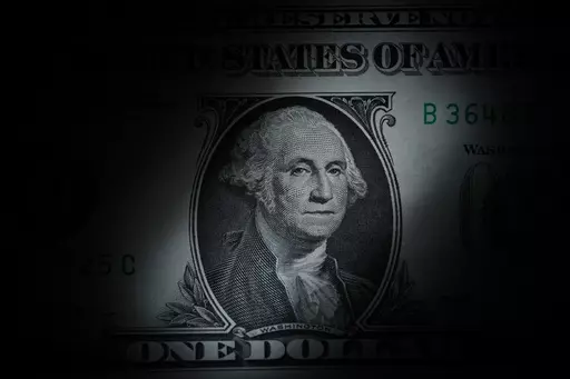 The likeness of George Washington is seen on a U.S. one dollar bill, March 13, 2023, in Marple Township, Pa. We often talk about 401(k)s and 403(b)s as if they’re the same, but they’re not. While both can help you save for retirement, 403(b)s have fewer consumer protections and can be a bad deal for the people — often teachers — they’re supposed to serve. If your employer offers a 403(b), research the plan thoroughly. (AP Photo/Matt Slocum, File)