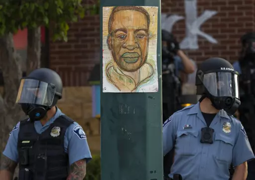 Minneapolis police stand outside the department's 3rd Precinct on May 27, 2020, in Minneapolis. Almost two years after George Floyd died at the hands of four Minneapolis police officers, Minnesota's Department of Human Rights was set Wednesday, April 27, 2022, to announce findings from its investigation into whether the city police department had a pattern or practice of racial discrimination in policing. (Carlos Gonzalez/Star Tribune via AP)