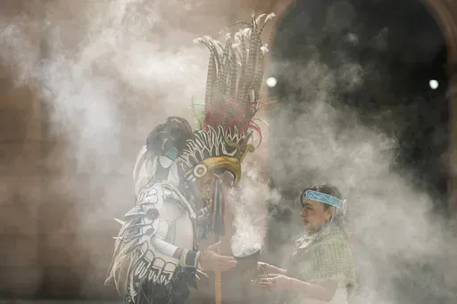 Mexica dancers burn incense during a ceremony commemorating the 503rd anniversary of the fall of the Aztec empire's capital, Tenochtitlan, in Mexico City, Tuesday, Aug. 13, 2024. (AP Photo/Eduardo Verdugo)