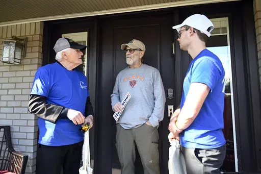 Republican Jewish Coalition members David Cuttner, left, and Noam Nedivi, right, talk with David Rabens about the election, Sunday, Oct. 27, 2024, in West Bloomfield Township, Mich. (AP Photo/Jose Juarez)