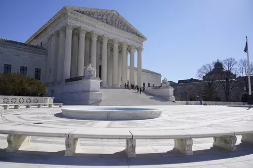 People stand on the steps of the U.S. Supreme Court, Feb.11, 2022, in Washington. The Supreme Court has agreed to take up a dispute over a medication used in the most common method of abortion in the United States. It’s the court’s first abortion case since it overturned Roe v. Wade last year. (AP Photo/Mariam Zuhaib, File)
