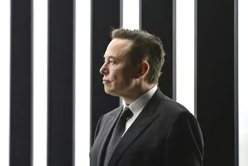 Elon Musk, Tesla CEO, attends the opening of the Tesla factory Berlin Brandenburg in Gruenheide, Germany, March 22, 2022. Musk, the world's richest man and the owner of SpaceX and Tesla, says he is a free speech absolutist who doesn't support the kind of content moderation that saw people like ex-President Donald Trump get banned for inciting violence (Patrick Pleul/Pool via AP, File)