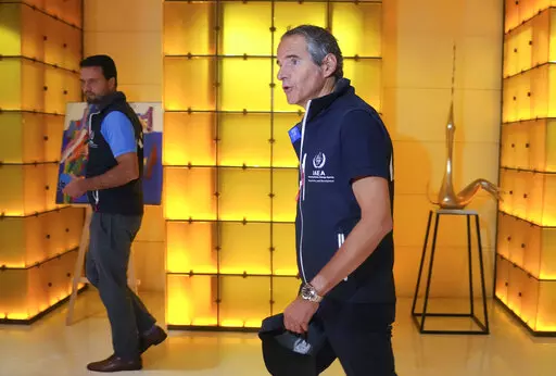 Director General of the International Atomic Energy Agency (IAEA) Rafael Mariano Grossi, right, walks in Kyiv, Ukraine, early Wednesday, Aug. 31, 2022. The U.N. nuclear watchdog team set off on an urgent mission to safeguard the Russian-occupied Zaporizhzhia atomic power plant at the heart of fighting in Ukraine, a long-awaited trip the world hopes will help avoid a radioactive catastrophe. (AP Photo/Efrem Lukatsky)