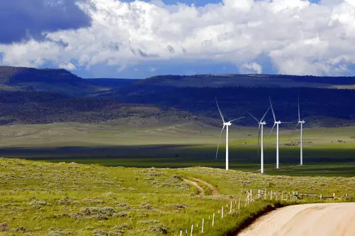 Clouds cast shadows near wind turbines at a wind farm along the Montana-Wyoming state line on June 13, 2022. The Biden administration is proposing a new permitting program for wind energy turbines, power lines and other projects that kill bald and golden eagles. (AP Photo/Emma H. Tobin, File)