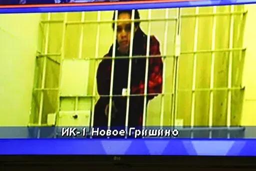 WNBA star and two-time Olympic gold medalist Brittney Griner is seen on the bottom part of a TV screen as she waits to appear in a video link provided by the Russian Federal Penitentiary Service a courtroom prior to a hearing at the Moscow Regional Court in Moscow, Russia, Tuesday, Oct. 25, 2022. A Russian court on Tuesday started hearing American basketball star Brittney Griner's appeal against her nine-year prison sentence for drug possession. (AP Photo/Alexander Zemlianichenko)