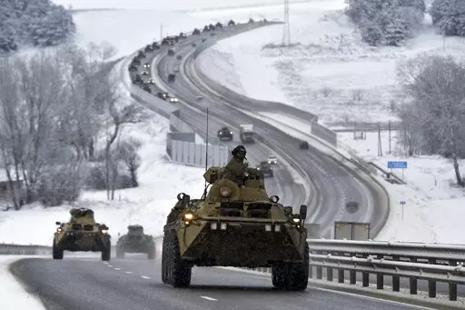 A convoy of Russian armored vehicles moves along a highway in Crimea, Tuesday, Jan. 18, 2022. Russia has concentrated an estimated 100,000 troops with tanks and other heavy weapons near Ukraine in what the West fears could be a prelude to an invasion. The Biden administration is unlikely to answer a further Russian invasion of Ukraine by sending U.S. combat troops. But it could pursue a range of less dramatic yet still risky options, including giving military support to a post-invasion Ukrainian