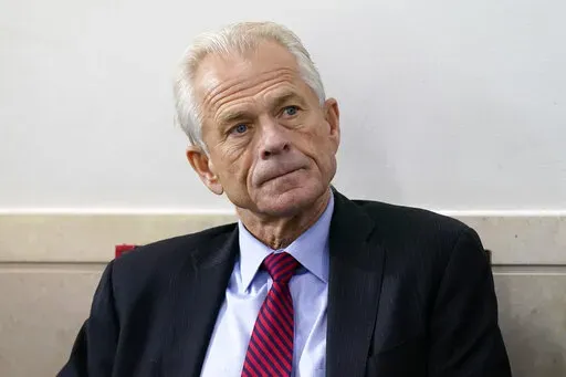 White House trade adviser Peter Navarro listens as President Donald Trump speaks during a news conference at the White House, Aug. 14, 2020, in Washington. The House committee investigating the U.S. Capitol insurrection subpoenaed former White House trade adviser Peter Navarro on Wednesday, Feb. 9, 2022, seeking to question an ally of former President Donald Trump who promoted false claims of voter fraud in the 2020 election. (AP Photo/Patrick Semansky, File)