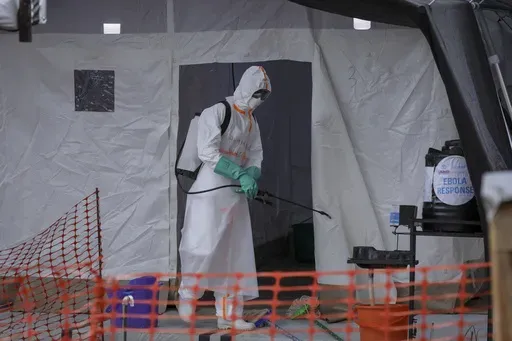 A medical worker disinfects a tent used for suspected Ebola victims inside the Ebola isolation center of Madudu Health Center III, in the village of Madudu, in the Mubende district of Uganda Tuesday, Nov. 1, 2022. (AP Photo/Hajarah Nalwadda, File)